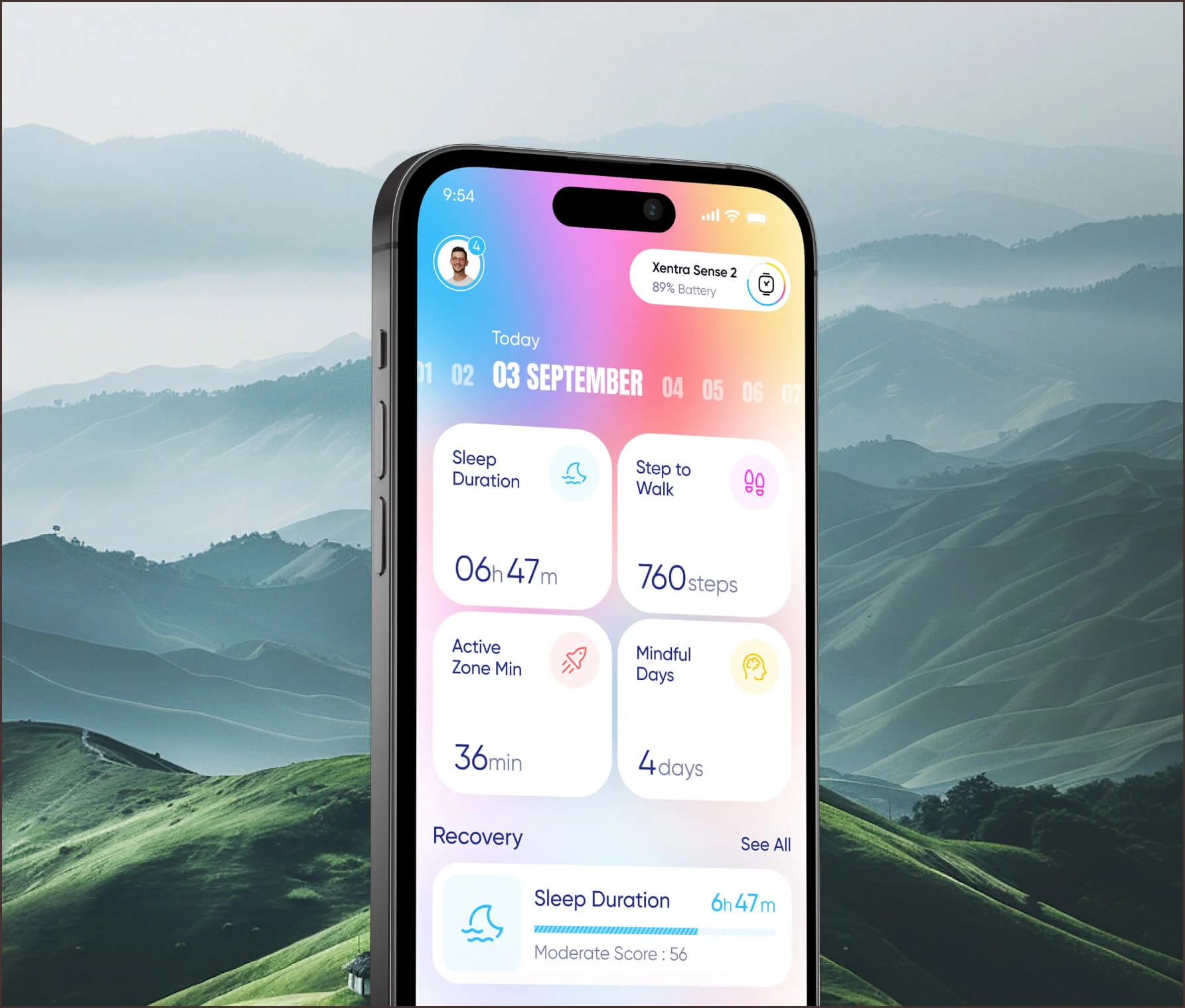 Phone showing a colourful health tracking app over misty hills