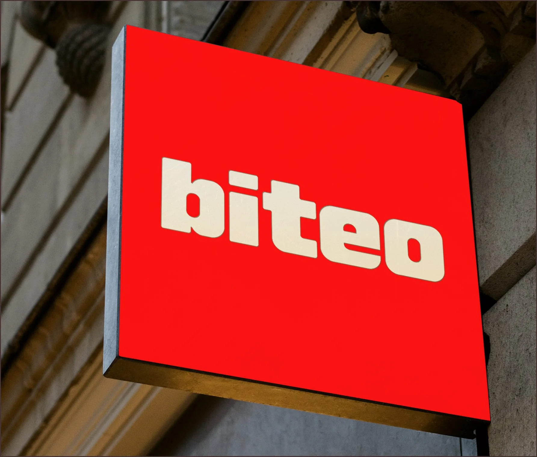 Red Biteo brand sign mounted on a stone building