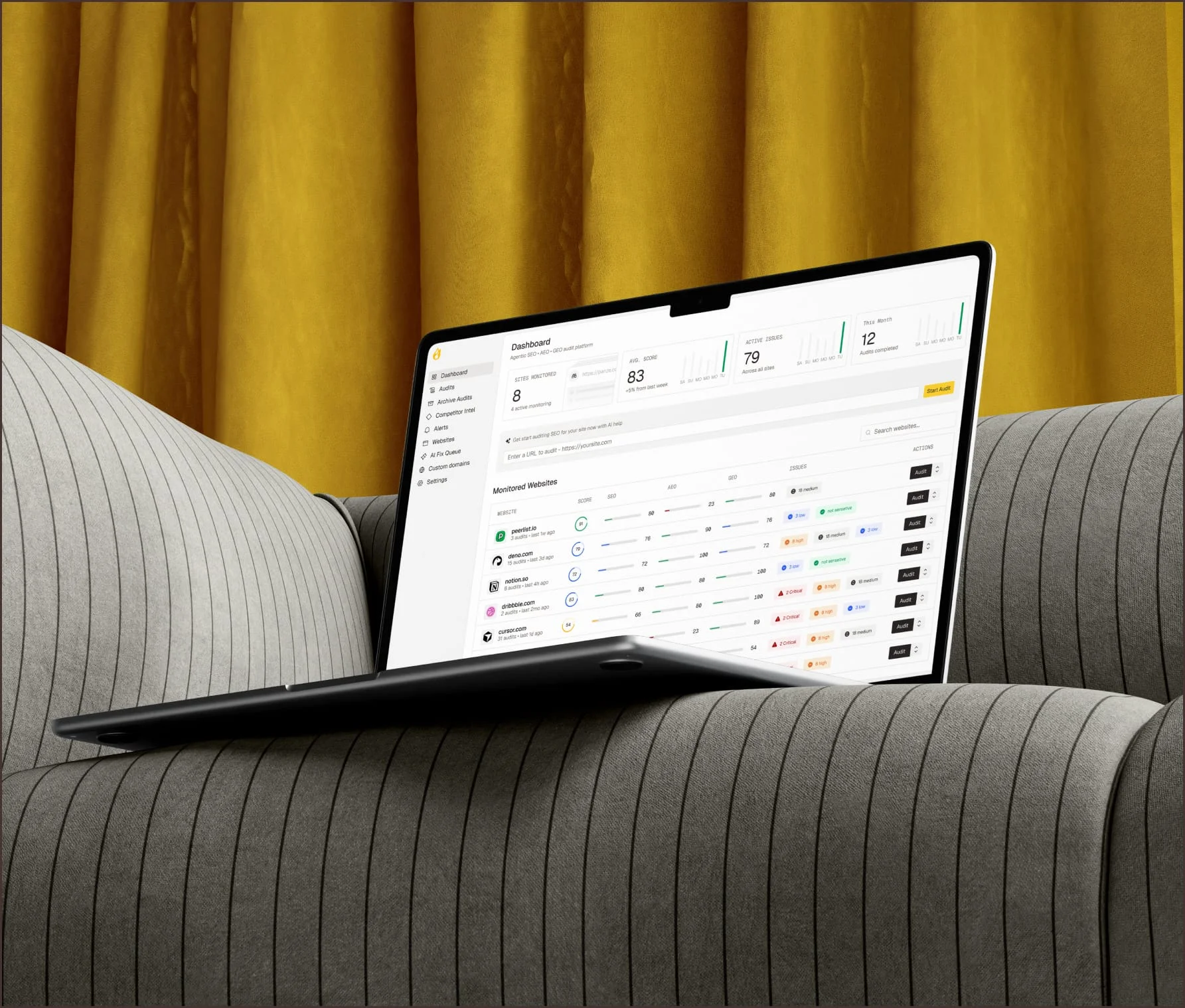 Redesigned SaaS data table interface on a laptop in front of a mustard curtain