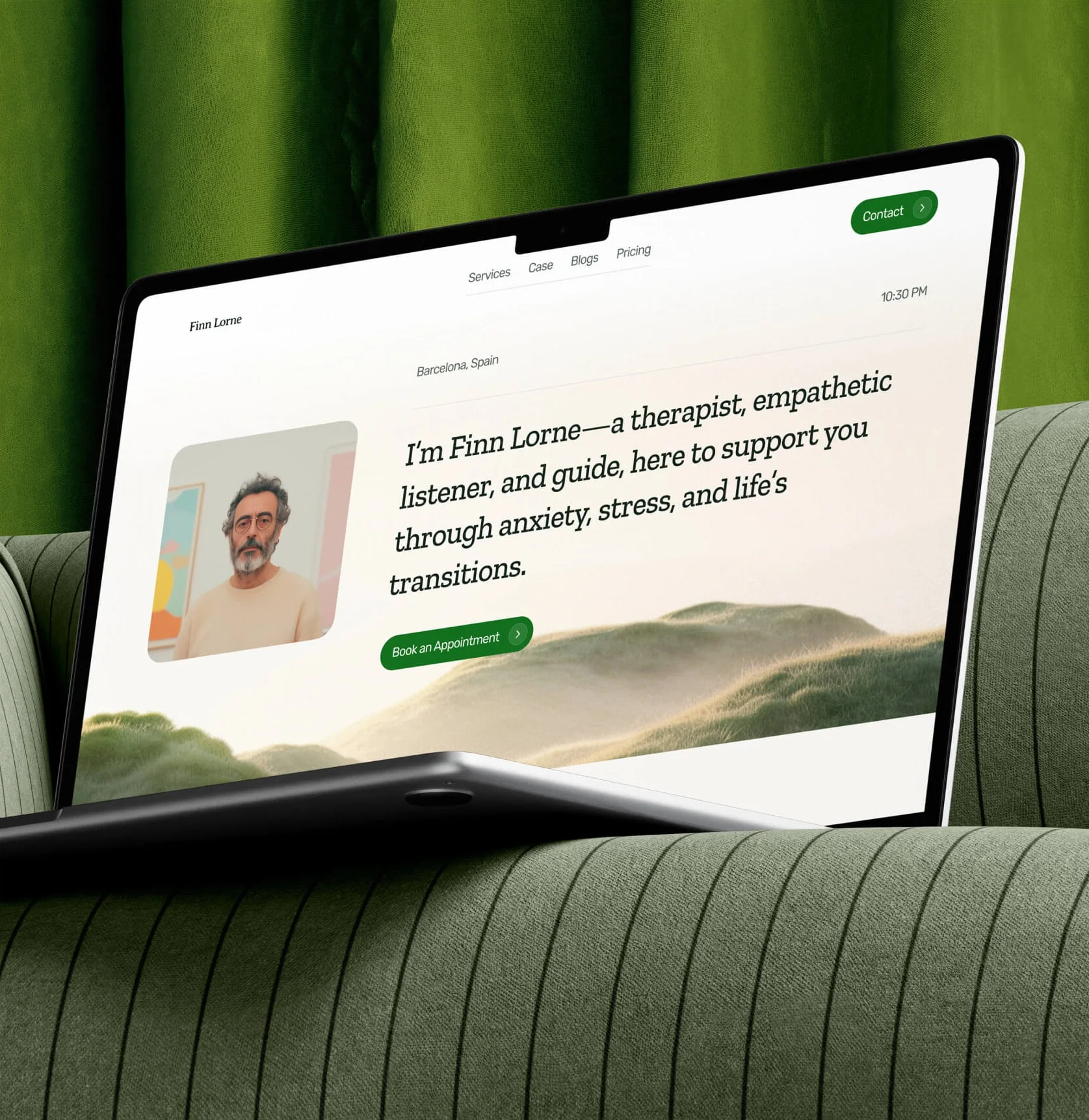 Therapist portfolio website on a laptop resting on a green sofa