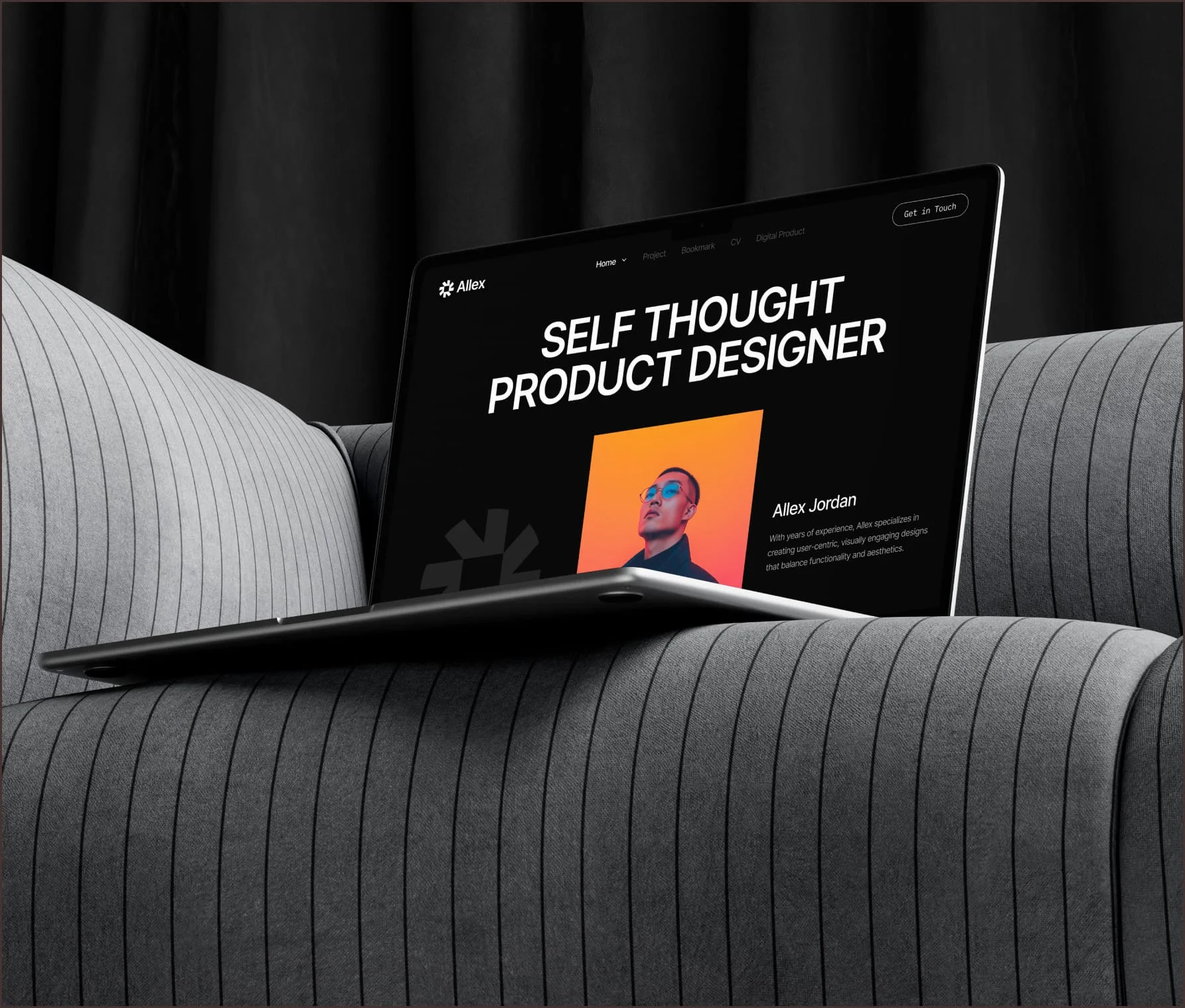 Product designer portfolio website headed “Self-Thought Product Designer” on a laptop against a black curtain